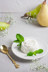Panna Cotta, traditional sweet Italian dessert, with mint and pear