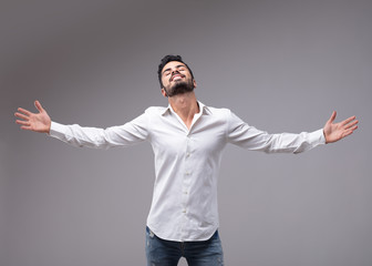 Man showing relieved gesture with spread arms
