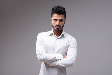 Portrait of serious bearded man with arms crossed