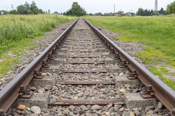 View of Railway tracks approaching to exterior facade of Auschwitz Birkenau concentration camp