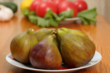 A figs fruits in a porcelain plate on a table