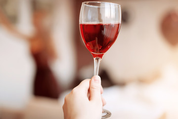 Hand holding a glass of wine