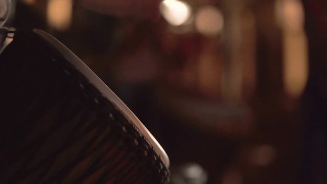 An African playing his drum (djembe) in a party at night