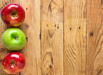 Beautiful Glossy Red Green Apples on Aged Plank Barn Wood Background. Autumn Fall Harvest Thanksgiving Concept. Rustic Vintage Style. High Resolution Poster Banner Streamer with Copy Space