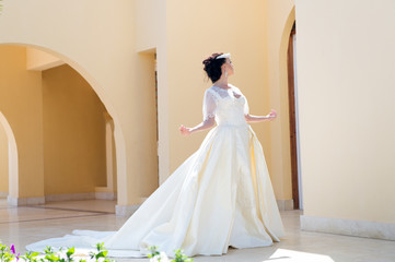 Fototapeta premium Bride in wedding dress. Bride woman in beautiful dress. bride at wedding day. elegant bride pose outdoor. It is perfect.
