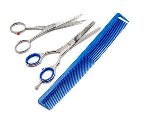 Scissors and hairbrush isolated on white