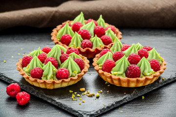 Delicious raspberry mini tarts tartlets with whipped cream