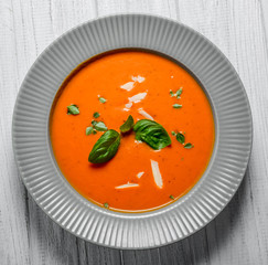 Tomato soup on wooden table