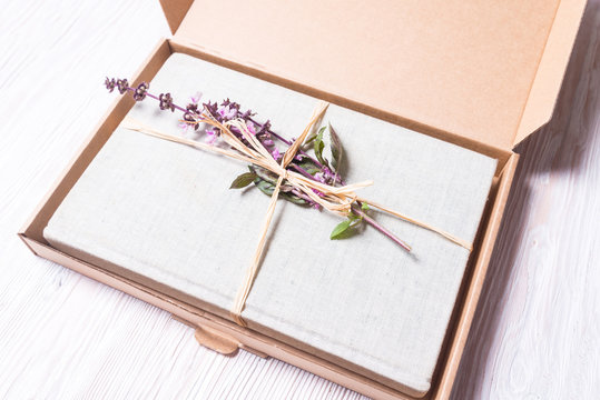 Wrapped book with flowers in cardboard gift box