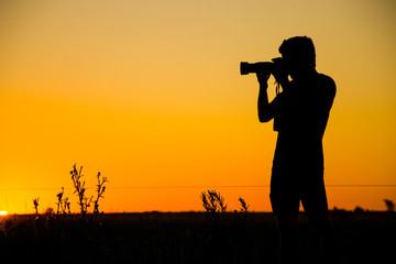 Photographer portrayed at sunset