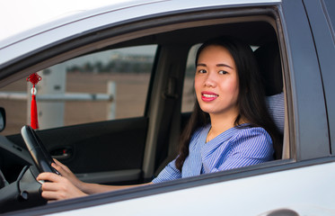 Asian female driver in a car