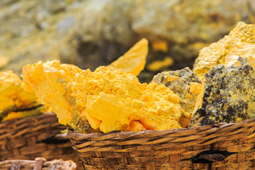 Baskets full of sulfur ore at Mount Ijen crater lake, Indonesia