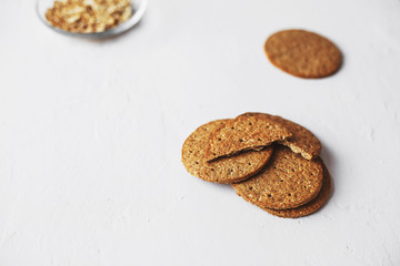 Healthy snack concept - wholegrain cookies stack on white background