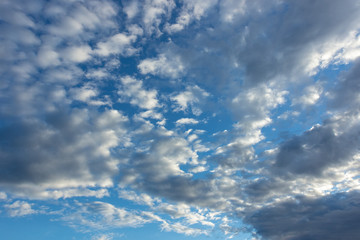A sky full of clouds beautifully lit by the setting sun
