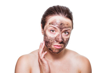 Obraz premium Skincare concept portrait of a female brunette with black charcoal film mask applied to her face