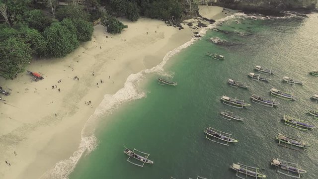 Indonesia traditional fishing boats docked in shores after fishing an aerial view, Papuma beach Jember