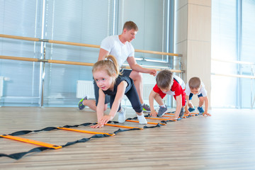 Happy sporty children in gym. Kids exercises