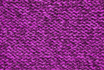 The texture of a knitted woolen fabric pink.