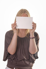 Blank card in front of female face