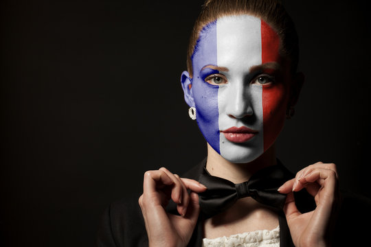 Portrait of woman with painted France Flag and bow tie