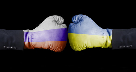 Boxing gloves with Russian and Ukrainian flag. Russia versus Ukraine concept.