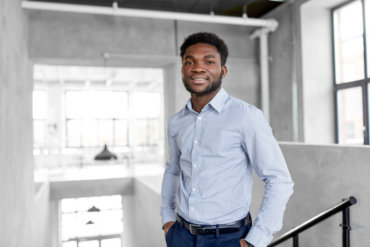 business and people concept - smiling african american businessman at office