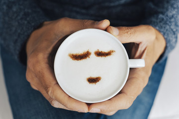 man with a cup of cappuccino