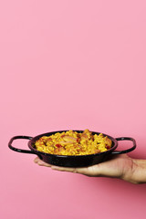 man with a typical spanish paella valenciana