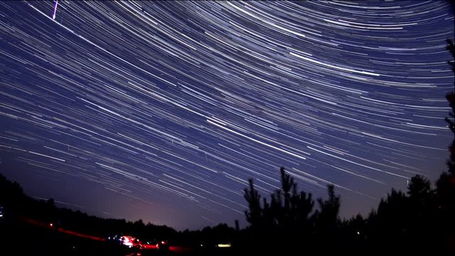 Star tracks, meteors and perseids against the background of the night sky timelapse