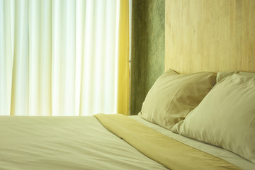 Fototapeta na wymiar Permesean Pillows And Permesean Towels On Bed In Bedroom.