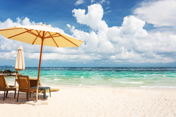 Beach Chair, Umbrella On The Beach And The Bright Green Sea, On A Good Day.