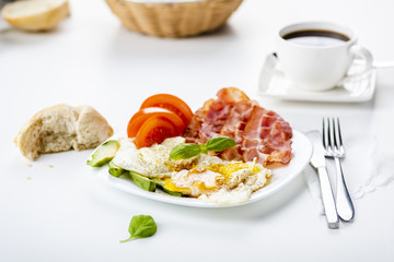 bacon and eggs with avocado and tomato, bread and coffee