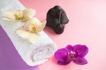 Obraz na płótnie Canvas Beautiful soap in the form of flowers and towel with lavender flowers for Spa treatments on a two-tone background. Selective focus.