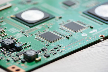 Close up photo of circuit board on wooden background