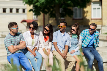 people, friendship and international concept - group of happy smiling friends in sunglasses in city