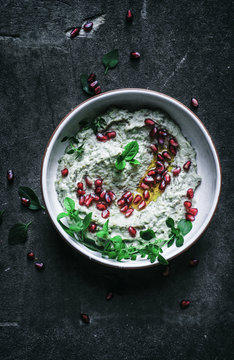 Baba Ghanoush with herbs, olive oil, and pomegranate.
