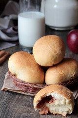 Homemade pirogi .Traditional Russian hand pies (pirozhki) with apple filling  in a wicker basket
