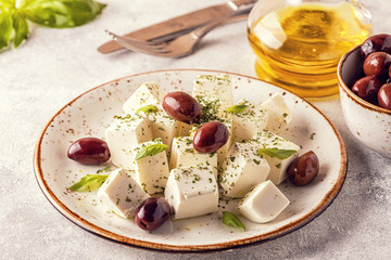 Greek cheese feta with oregano and olives.
