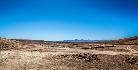 Desert road with Atlas Mountains near Kasbah Ait Ben Haddou, Morocco