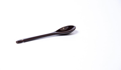 Black kerosene spoon on a white background