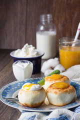 Cottage cheese pancakes on a plate with sour cream and orange jam. Syrniki. Traditional Ukrainian and Russian cuisine