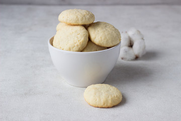 Coconut cookies in a bowl on a light background.