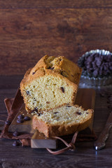 Homemade pound cake with chocolate drops on a wooden cutting board. Homemade pastry for breakfast or dessert.
