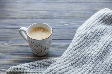 Cup of coffee with marshmallow on a wooden background.