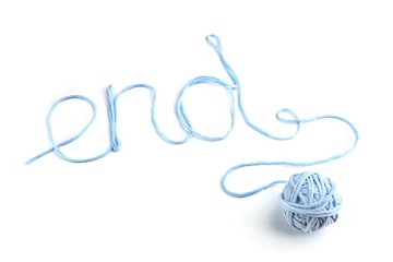 Word end made of blue thread and thread ball isolated on white background. Cotton thread ball with word end.
