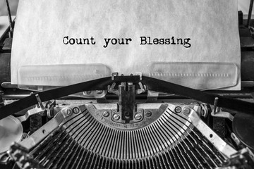 Count your Blessing, the text is typed in a vintage typewriter. Old paper, close-up.