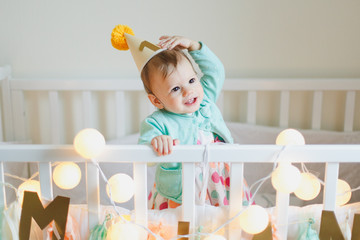 Portrait of cute baby girl wearing birthday hat, one year old birthday celebration .