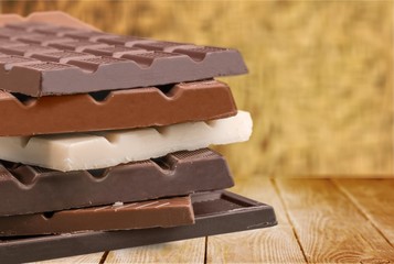 Delicious chocolates on wooden background
