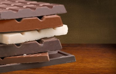 Delicious chocolates on wooden background
