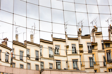 office center glass wall with reflextion of opposits situated building
